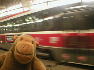 Mr Monkey in front of a moving streetcar