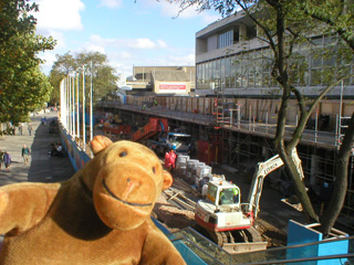 Mr Monkey looking at the South Bank from the Hungerford Bridge