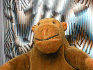 Animation of Mr Monkey in front of an optical illusion