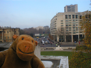 Mr Monkey looking up Park Lane from the top of the Wellington Arch