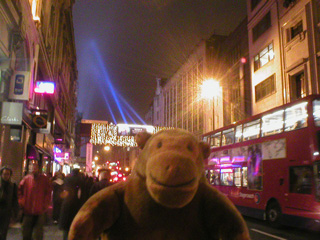 Mr Monkey looking at searchlights and lights on Oxford Street