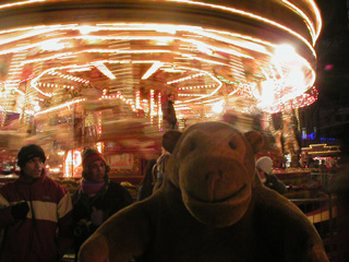 Mr Monkey in front of a carousel