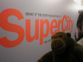 Mr Monkey beside the SuperCity sign in Urbis