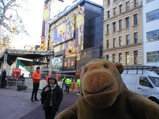 Mr Monkey watching BAFTA banners being put up in Leicester Square