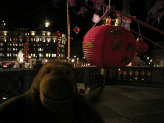 Mr Monkey looking at Chinese decorations in the dark