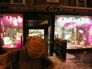 Mr Monkey outside Partners and Crime bookshop