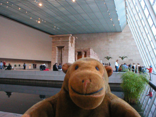 Mr Monkey with an Egyptian temple behind him