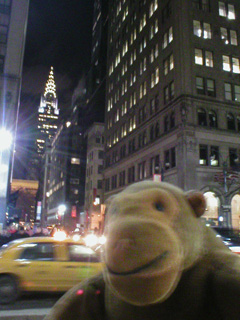 Mr Monkey looking the Chrysler building from Fifth Avenue