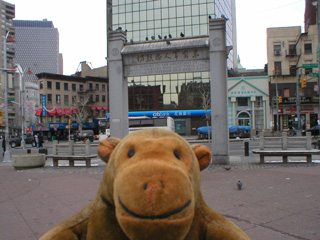 Mr Monkey in front of an Oriental memorial arch