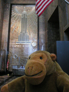 Mr Monkey in front on an Art-Deco map and elavation of the ESB