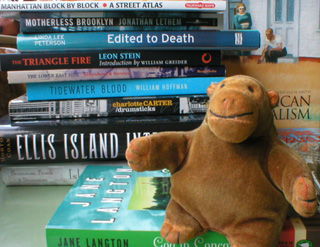 Mr Monkey with a pile of books bought in New York