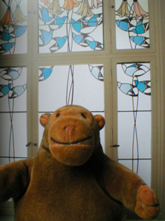 Mr Monkey in front of a picture of a window by Baillie Scott