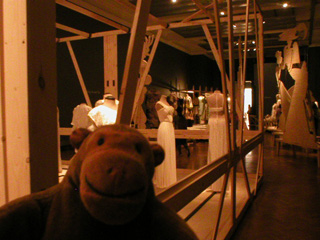 Mr Monkey looking past the dresses to the giant silhouettes