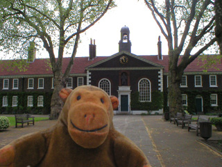 Mr Monkey in front of the chapel of the almshouses