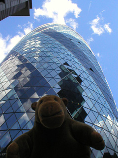 Mr Monkey looking up at the Swiss Re tower