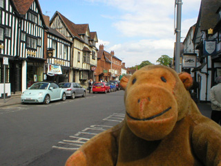 Mr Monkey looking at a row of houses on Sheep Street