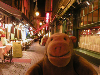 Mr Monkey in the Petite Rue des Bouchers after dark