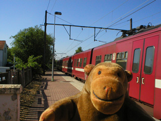 Mr Monkey on the platform at Waterloo, with a train