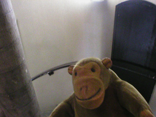 Mr Monkey climbing a spiral staircase