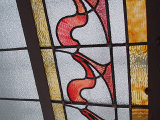 Red and amber patterned glass in the ceiling of the first floor