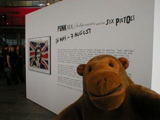 Mr Monkey reading the exhibition description