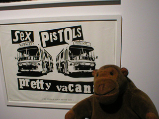 Mr Monkey with a poster for Pretty Vacant