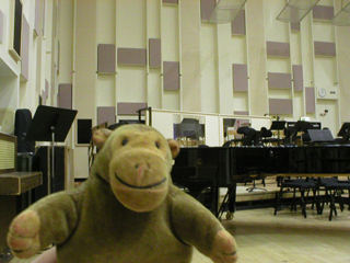Mr Monkey in front of a grand piano