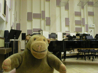 Mr Monkey in front of a grand piano