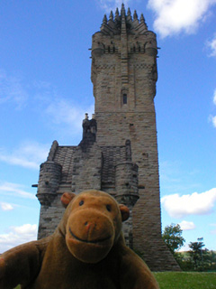 Mr Monkey walking around the side of the Monument