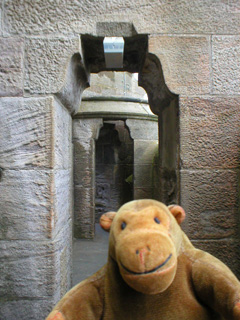 Mr Monkey walking around the parapet of the monument