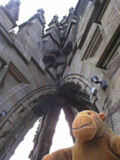 Mr Monkey looking up at the crowned top of the monument