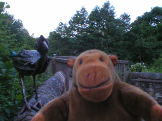 Mr Monkey with a metal bird on a bridge