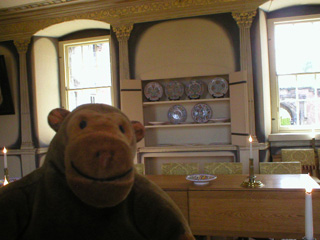 Mr Monkey looking at the china cupboard in the dining room