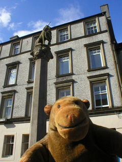Mr Monkey looking up at Stirling's mercat cross