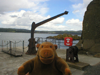 Mr Monkey examining the old crane on the quay