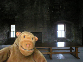 Mr Monkey in an upstairs room with tables and a chandelier