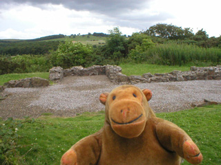 Mr Monkey in front of the remains of the chapel