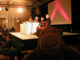 Mr Monkey listening to a panel of writers