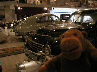 Mr Monkey looking at old Saab and Volvo cars