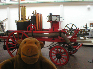 Mr Monkey looking at a horse drawn fire engine