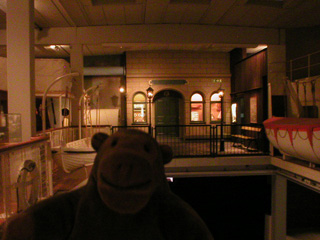 Mr Monkey surrounded by recreated dock and boat scenes