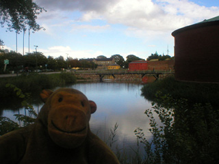 Mr Monkey looking across the moat at the bridge