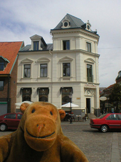 Mr Monkey looking at a corner restaurant