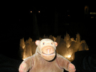 Mr Monkey in front of the Stortorget fountain at night