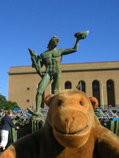 Mr Monkey looking at the statue of Poseidon