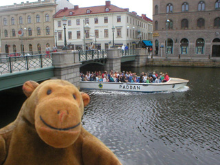 Mr Monkey watching a tour boat come out from under a bridge