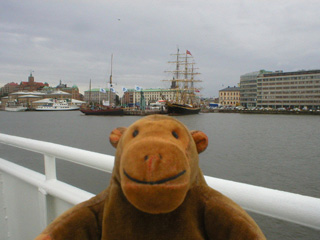 Mr Monkey looking at moored sailing ships