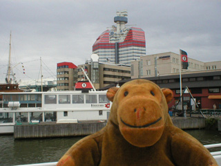 Mr Monkey looking at ferries on the quayside
