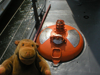 Mr Monkey looking at the emergency buoy of the Nordkaparen