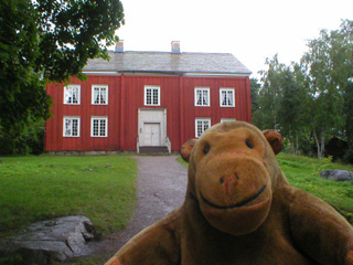 Mr Monkey of a red painted farmhouse